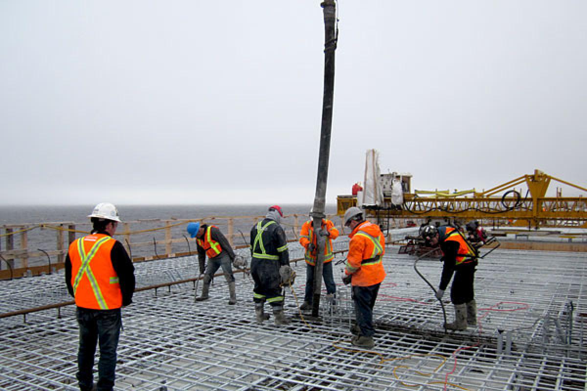 un ouvrier du bâtiment sur le chantier mesure la longueur de l